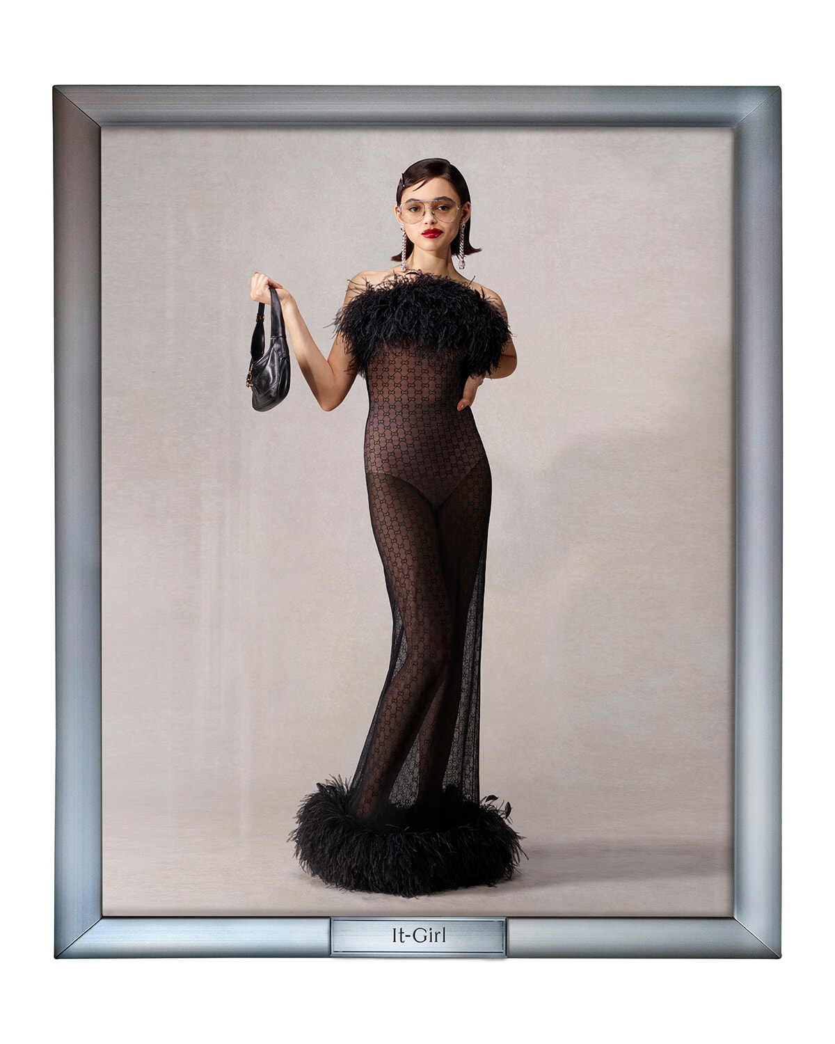It-Girl fashion portrait: woman in a sheer black lace gown with feathered neckline, holding a small clutch.