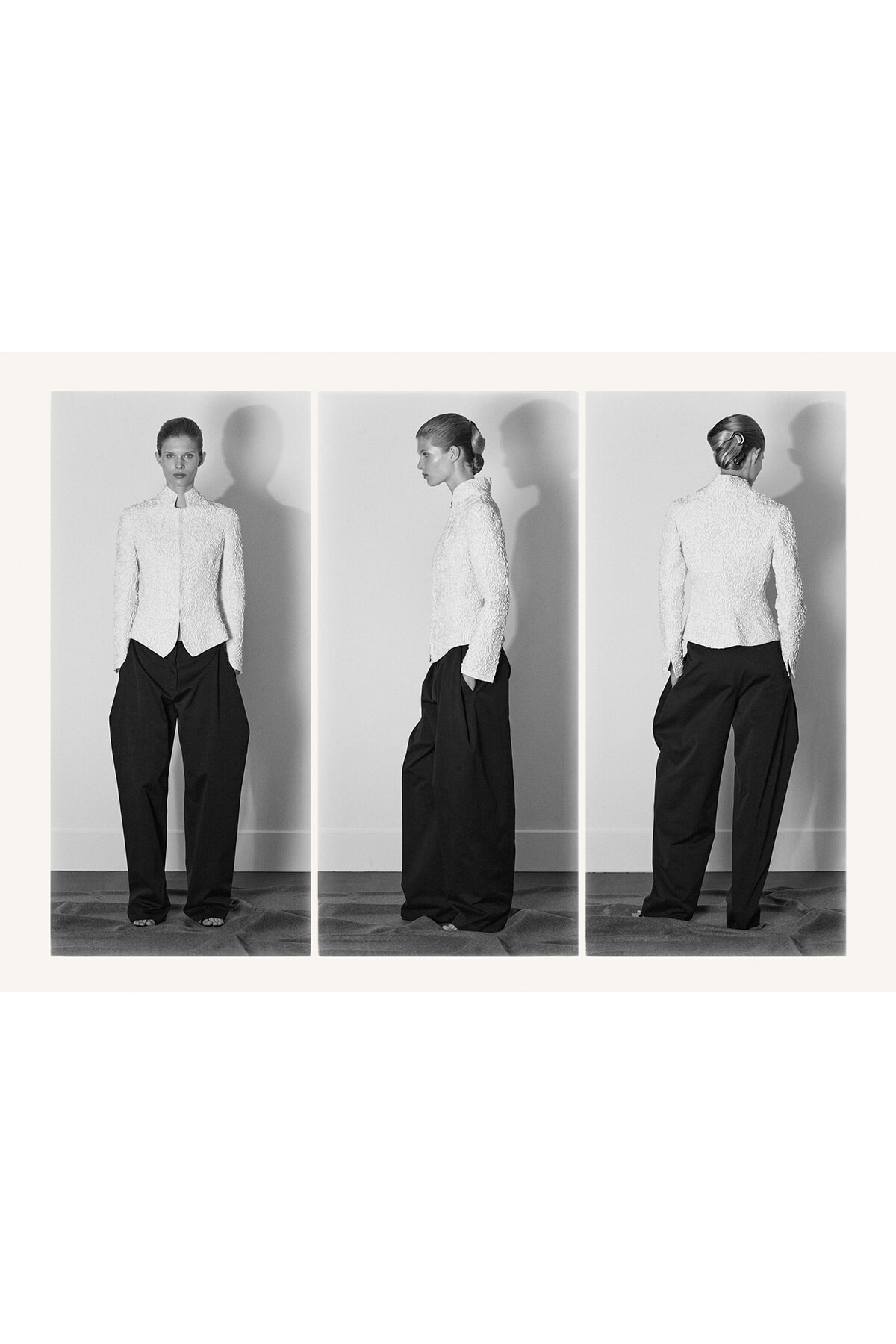Triptych of a model wearing a textured white blazer and wide black trousers, shown from front, side, and back.