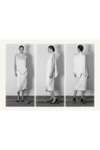 Black-and-white triptych of a model in a loose, pleated white dress shown from the front, side, and back.