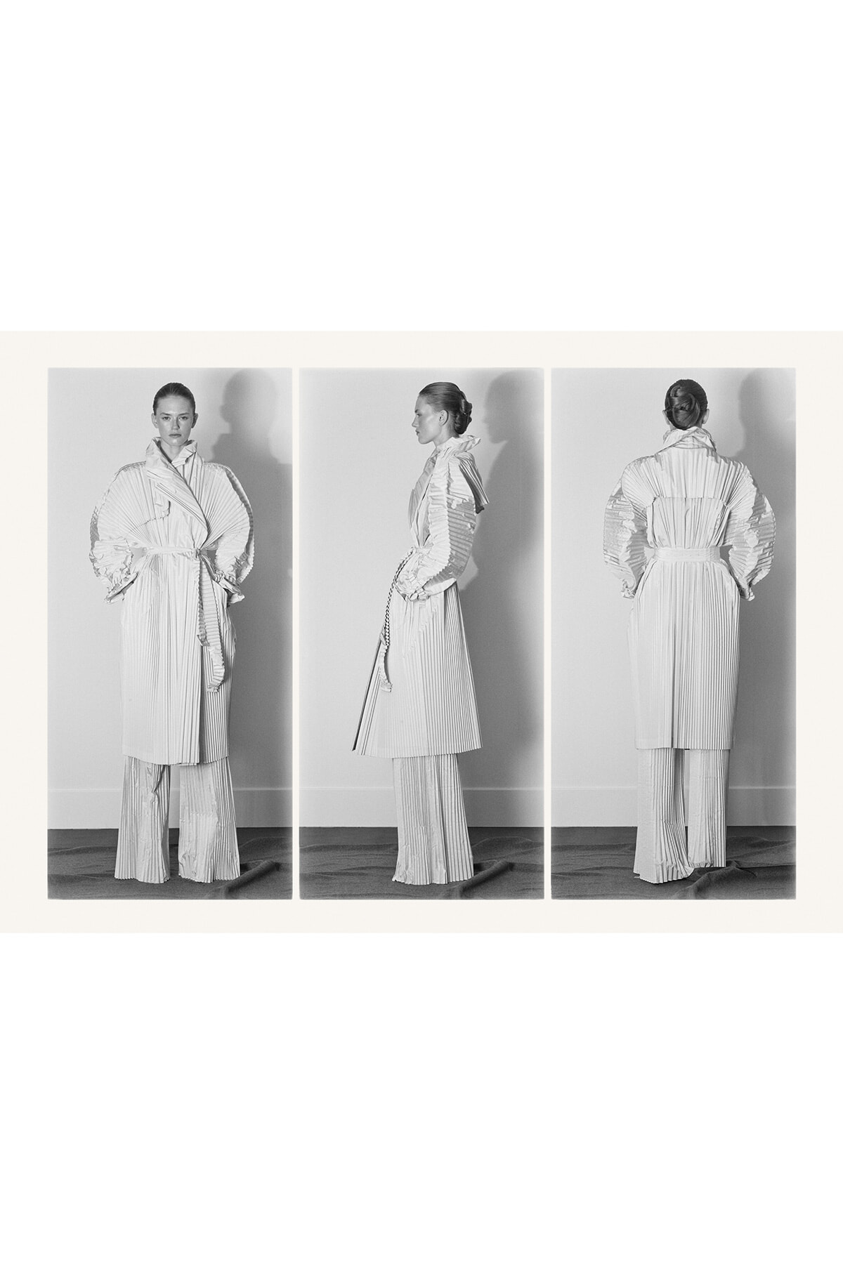 Triptych fashion image: a model in a pleated light trench and matching wide-leg pants, shown front, side, and back in black-and-white.