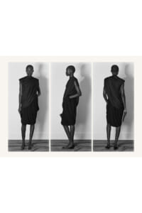 Triptych of a model in a draped black dress shown from front, side, and back against a neutral wall.
