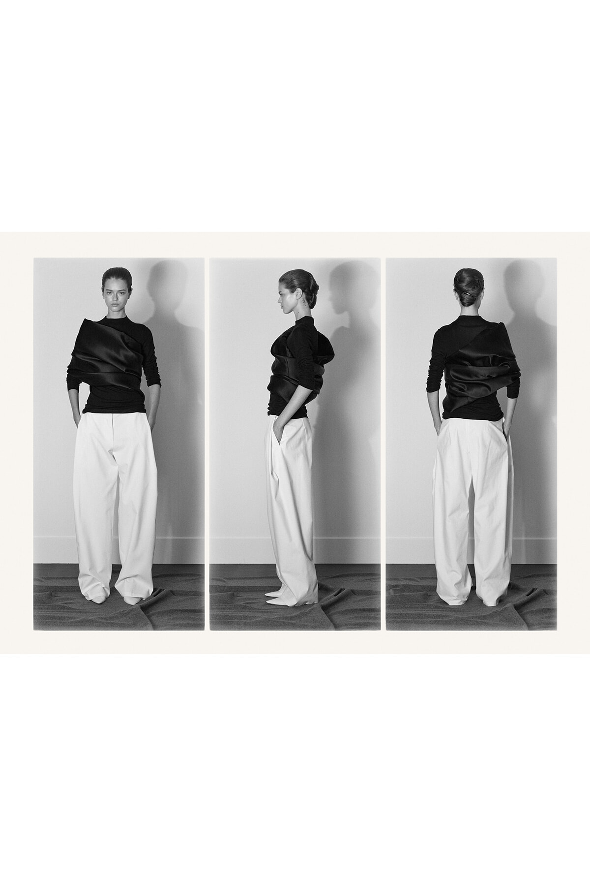 Triptych of a female model wearing a black draped top and wide white trousers, shown from front, side, and back in a studio setting.