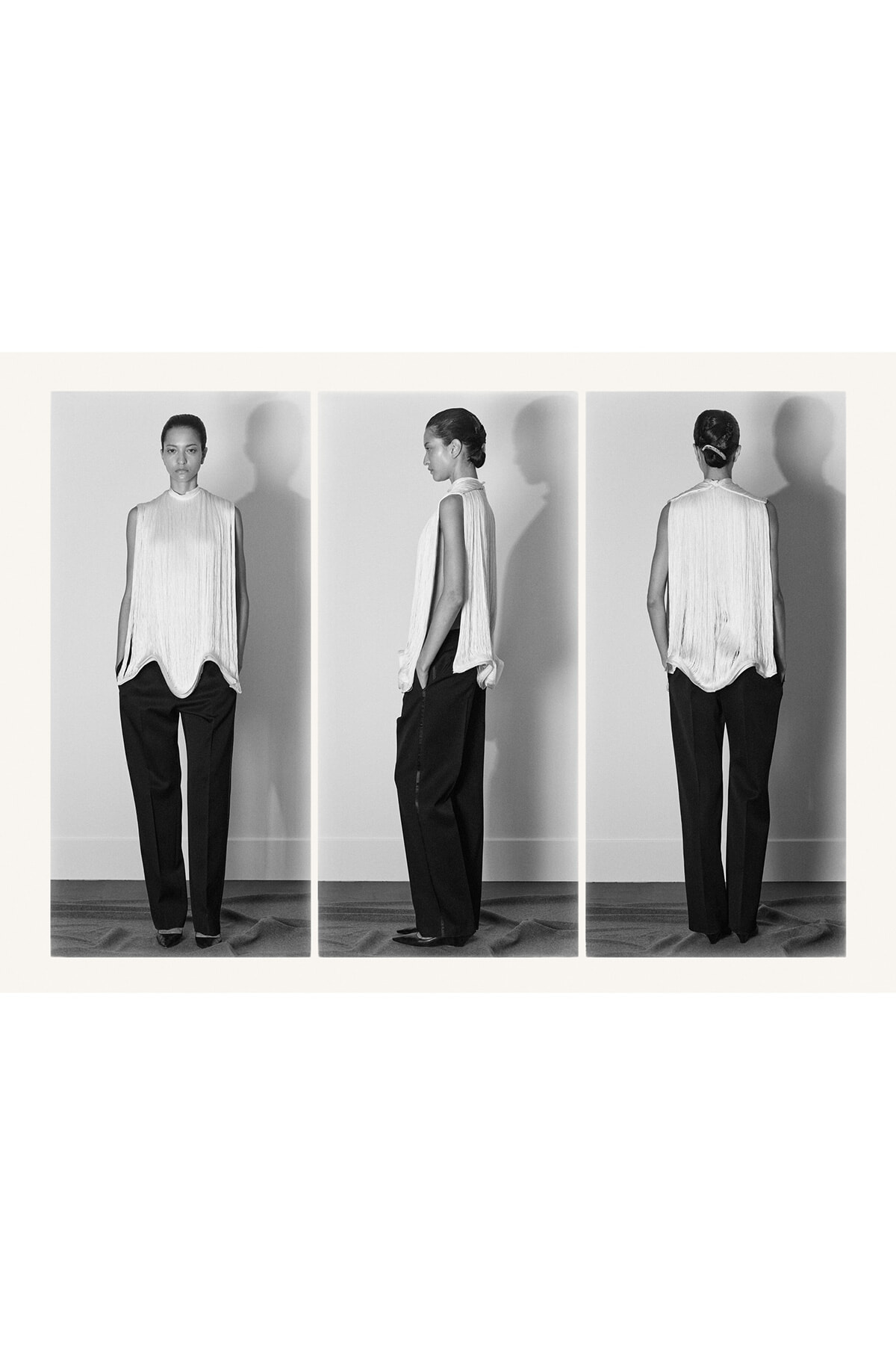 Triptych of a model in a sleeveless pleated white top and black wide-leg pants, shown front, side, and back.