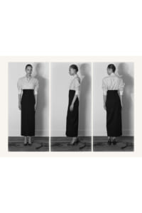 Triptych photo of a woman in a light button-down shirt and black midi skirt, shown from front, side, and back against a plain wall.