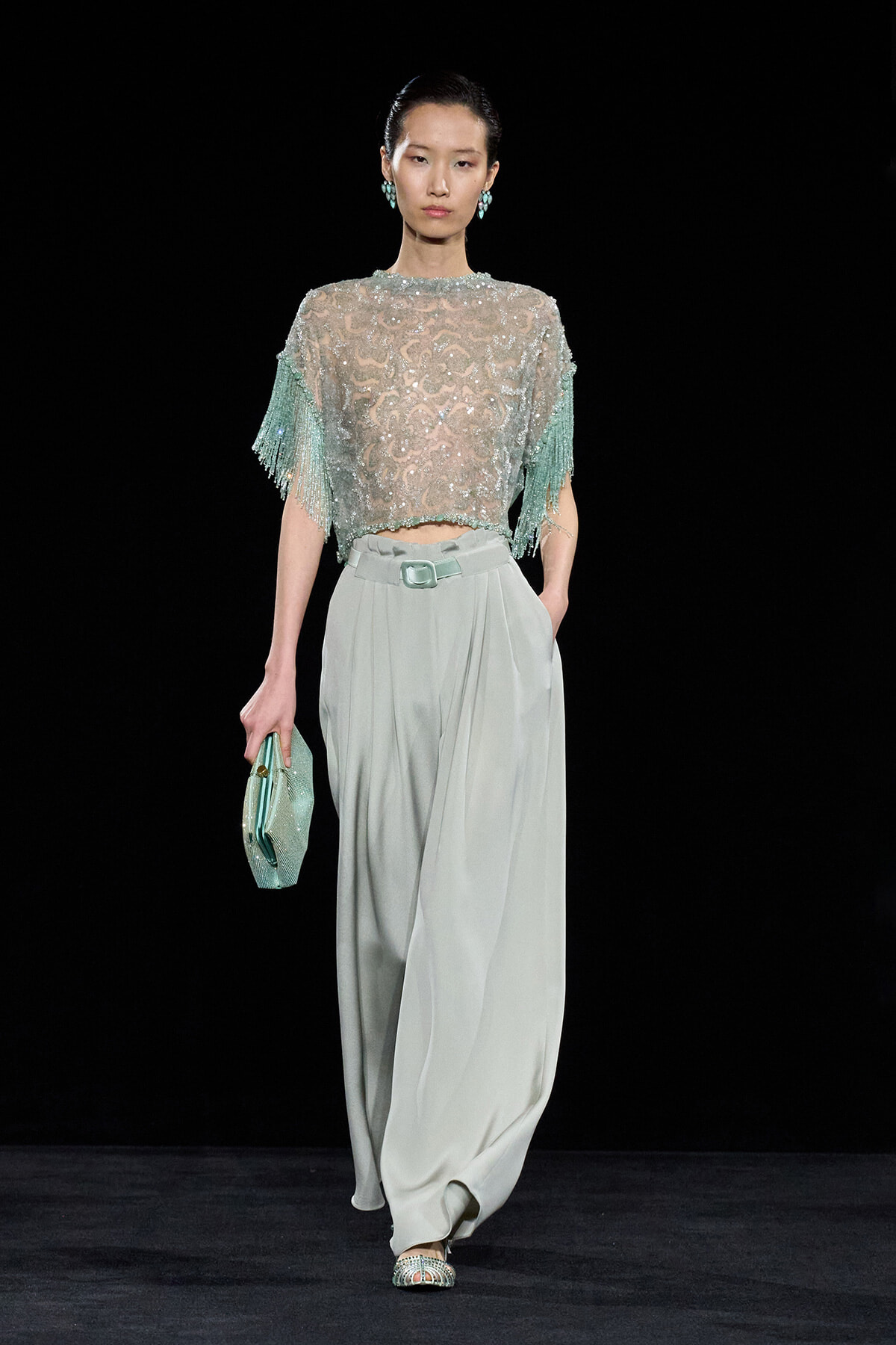 Runway look: mint beaded lace top with fringe sleeves paired with pale gray wide-leg trousers and a mint clutch.