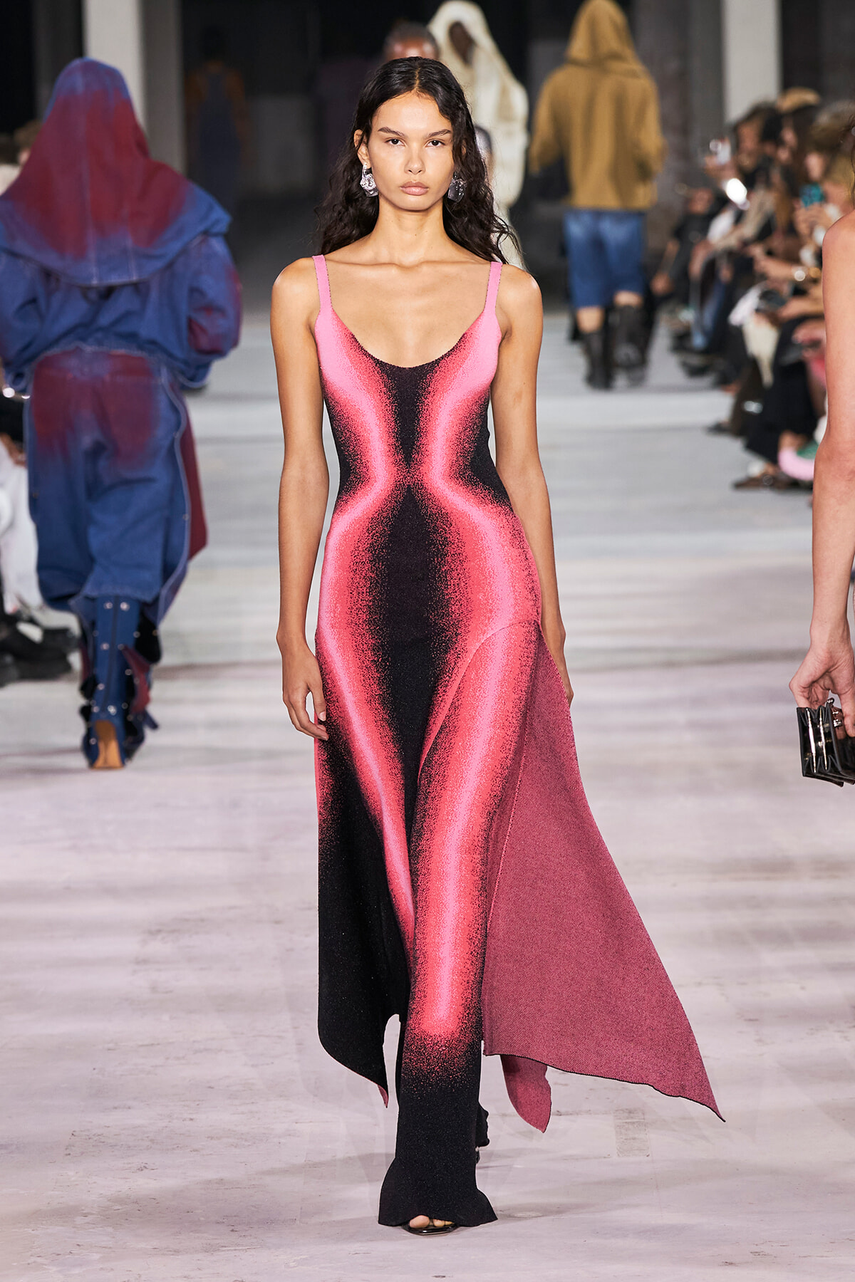 Model walks the runway in a pink and black metallic gradient gown with thin straps and an asymmetric hem.